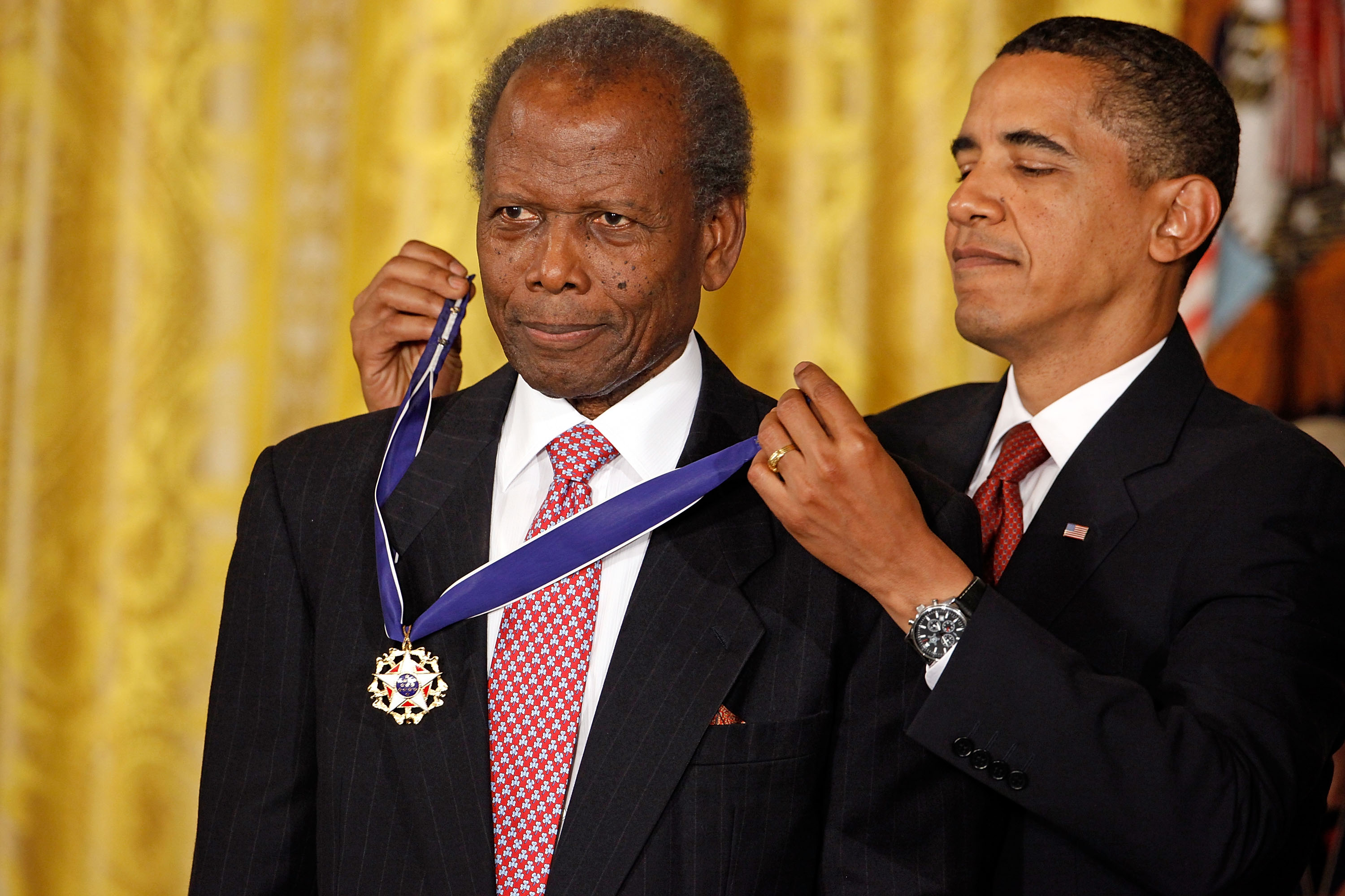 Former President Barack Obama, right, presents the Medal of Freedom to Academy Award-winning actor Sidney Poitier during a ceremony in the East Room of the White House, Aug. 12, 2009, in Washington, D.C.