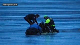 First responders helping man from frozen lake