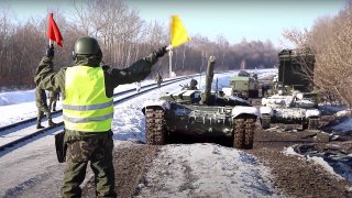 In this photo taken from video provided by the Russian Defense Ministry Press Service on Wednesday, Feb. 16, 2022, Russian army tanks are loaded onto railway platforms to move back to their permanent base after drills in Russia.