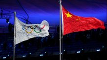 The Chinese and Olympic flags fly during the opening ceremony of the 2022 Winter Olympics, Friday, Feb. 4, 2022, in Beijing.