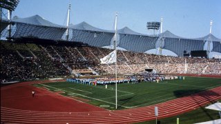 The Olympic flag, foreground, and flags of participating nations are flown at half-staff during a commemoration ceremony for the victims of the Munich Olympic massacre at the Munich, southern Germany, Olympic stadium in this Sept. 6, 1972 file photo.