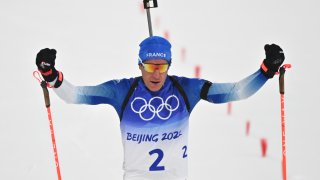 Quentin Fillon Maillet of Team France celebrates winning gold during the Biathlon Men's 12.5km Pursuit at the 2022 Winter Olympics, Feb. 13, 2022, in Zhangjiakou, China.