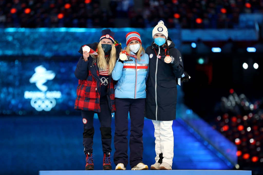 Gold medallist Therese Johaug of Team Norway, center, silver medallist Jessie Diggins of Team United States, left, and bronze medallist Kerttu Niskanen of Team Finland  pose with their medals during the Women's 30km Mass Start medal ceremony at the 2022 Winter Olympics Closing Ceremony, Feb. 20, 2022, in Beijing.