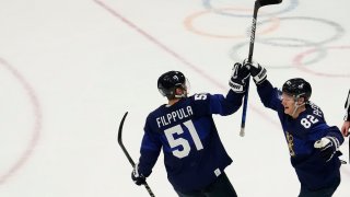 Feb 18, 2022; Beijing, China; Team Finland forward Harri Pesonen (82) celebrates with Team Finland forward Valtteri Filppula (51) after scoring an empty-net goal against Team Slovakia in the third period during the Beijing 2022 Olympic Winter Games at National Indoor Stadium.