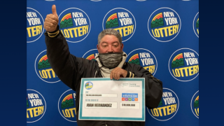 Juan Hernandez, of Uniondale, poses with his lottery winnings.