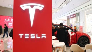 Customers experience new energy electric vehicles at a Tesla store in Shanghai, China, On December 4, 2021.