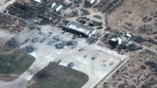 This satellite image provided by Maxar Technologies shows destroyed Russian helicopters on the tarmac at an airfield in Kherson, Ukraine on Wednesday, March 16, 2022.