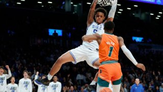 Paolo Banchero #5 of the Duke Blue Devils dunks as Anthony Walker #1 of the Miami (Fl) Hurricanes defends during the second half in the 2022 Men’s ACC Basketball Tournament – Semifinals at Barclays Center on March 11. The Blue Devils won 80-76.