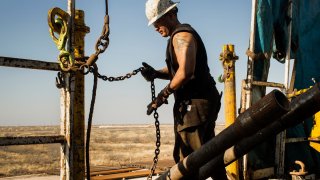 A worker on a drilling rig in the Permian basin outside of Midland, Texas.