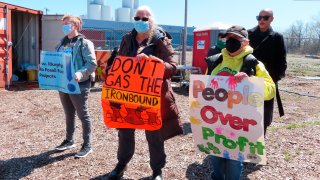 Activists protest against a proposed backup power plant for a sewage treatment facility in Newark, New Jersey, April 20, 2022.