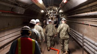 John Korka, Commander, Naval Facilities Engineering Systems Command (NAVFAC), and Chief of Civil Engineers, leads Navy and civilian water quality recovery experts through the tunnels of the Red Hill Bulk Fuel Storage Facility, near Pearl Harbor