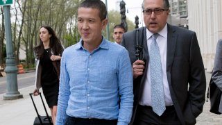 Former Goldman Sachs executive Roger Ng, center, leaves Brooklyn Federal court with attorney Marc Agnifilo, right, May 6, 2019, in New York