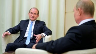 FILE - Ukrainian tycoon Viktor Medvedchuk, left, speaks to Russian President Vladimir Putin during a meeting at the Novo-Ogaryovo residence outside Moscow, Russia, Oct. 6, 2020. The detention on Tuesday, April 12, 2022 of fugitive Ukrainian oligarch Viktor Medvedchuk, who is both the former leader of a pro-Russian opposition party and a close associate of Russian leader Vladimir Putin, was met with enthusiasm in Kyiv — and irritation in Moscow.