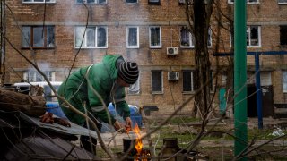 Volodymyr Lukyanovych, 63, cooks his dinner outside his house since his building was destroyed by Russian shelling in Irpin, on the outskirts of Kyiv, on Wednesday, April 20, 2022. Citizens of Irpin are still without electricity, water and gas after since the Russian invasion began.