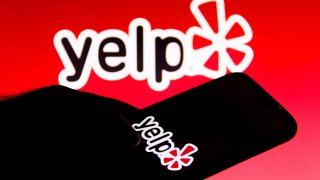 In this photo illustration a Yelp logo is seen on a