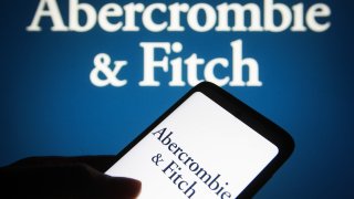 In this photo illustration, the Abercrombie & Fitch (A&F) logo is seen on a smartphone screen and in the background.
