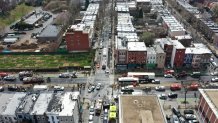 An aerial view shows emergency personnel in Brooklyn's Sunset Park neighborhood after at least 16 people were injured during a rush-hour shooting in New York, April 12, 2022.