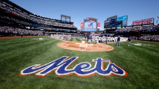 Members of the Arizona Diamondbacks and the New York Mets stand for the National Anthem during the Mets home opening game at Citi Field
