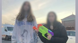 Students playing water gun assassins game