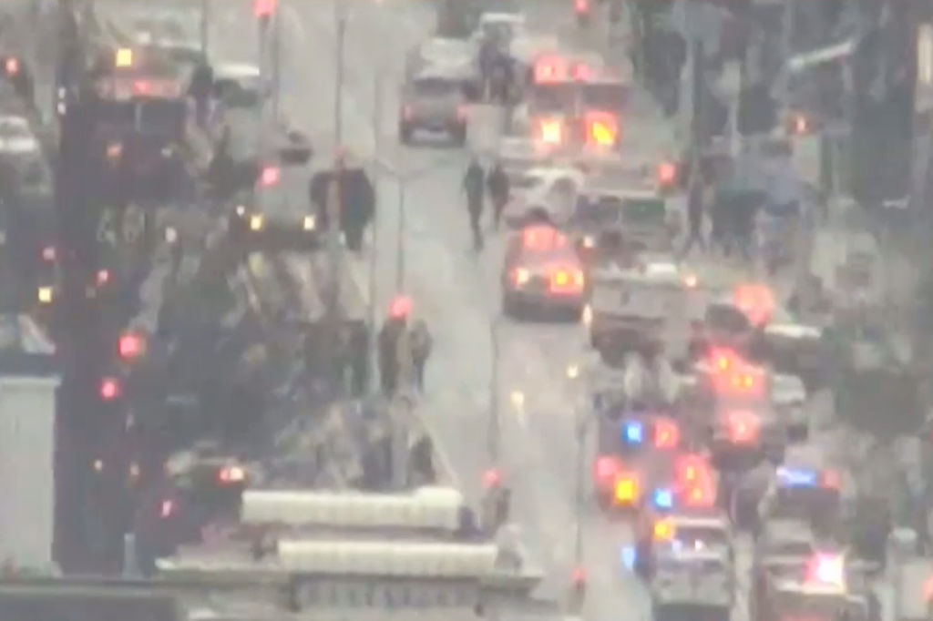 Police and first responders swarm the Brooklyn neighborhood of Sunset Park in New York, after multiple people were shot or hurt at the height of morning rush hour, April 12, 2022.