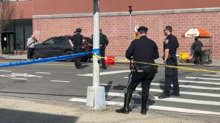 Police investigate scene of pedestrian crash near a Queens shopping center.