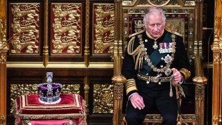 FILE - Britain’s Prince Charles, Prince of Wales (R) sits by the The Imperial State Crown (L) in the House of Lords Chamber, during the State Opening of Parliament, in the Houses of Parliament, in London, on May 10, 2022.