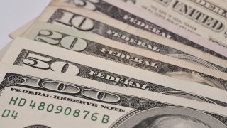 Five, ten, twenty, fifty and one hundred dollar bills spread out