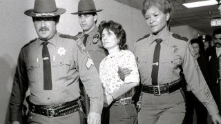 Weather Underground member Katherine Boudin is led from Rockland County Courthouse in New City, New York, by sheriff's officers