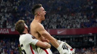 Frankfurt's Rafael Santos Borre, right, celebrates after scoring the winning penalty during a shootout at the end of the Europa League final soccer match between Eintracht Frankfurt and Rangers FC at the Ramon Sanchez Pizjuan stadium in Seville, Spain, Wednesday, May 18, 2022.