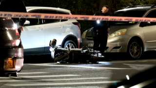 Delivery worker's bike lay behind after a fatal shooting in Queens.