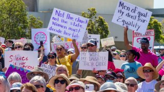 People attending the Bans Off Abortion rally held at Centennial Park in Santa Ana on Saturday, May 14, 2022, after a leaked draft opinion showed the Supreme Court was poised to overturn Roe v. Wade.