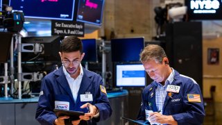In this photo provided by the New York Stock Exchange, traders Orel Partush, left, and Robert Charmak work on the floor, Friday, June 10, 2022.