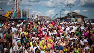 Dressed up men and women pose for a picture at the Coney Island Mermaid Parade.