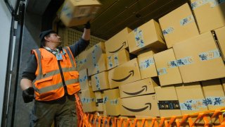 Amazon worker stacking boxes