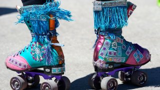 A roller skater stands on skates after performing at a press conference