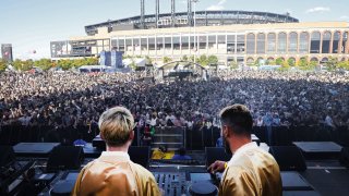 DJs perform in front of large crowd at 2021 Governors Ball with Citi Field in the background.