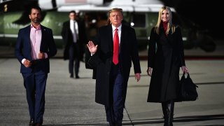 US President Donald Trump (C), daughter Senior Advisor Ivanka Trump and son Donald Trump Jr. (L) make their way to board Air Force One before departing from Dobbins Air Reserve Base in Marietta, Georgia on January 4, 2021.