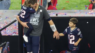 Then New England Patriots quarterback Tom Brady walks his children off the victors’ podium during the Super Bowl LI between the New England Patriots and Atlanta Falcon on February 5, 2017 at NRG Stadium in Houston, Texas.