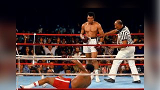 Referee Zack Clayton, right, steps in after challenger Muhammad Ali, second from right, knocked down defending heavyweight champion George Foreman, bottom