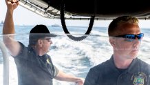 Lieutenant Sean Reilly and Zachary Kochanowski, environmental conservation officers with the New York State Police, patrol for sharks in the ocean off of Robert Moses State Park, July 27, 2022, in Babylon, N.Y.