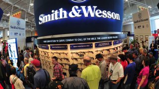 Convention goers look at weapons at the Smith and Wesson booth last April at the 2015 NRA Annual Convention in Nashville, Tenn.