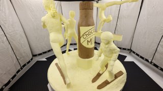 Female athletes depicted through a butter sculpture with a chocolate milk bottle in the center