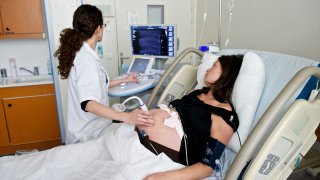 Pregnant woman gets an ultrasound at the doctor's office