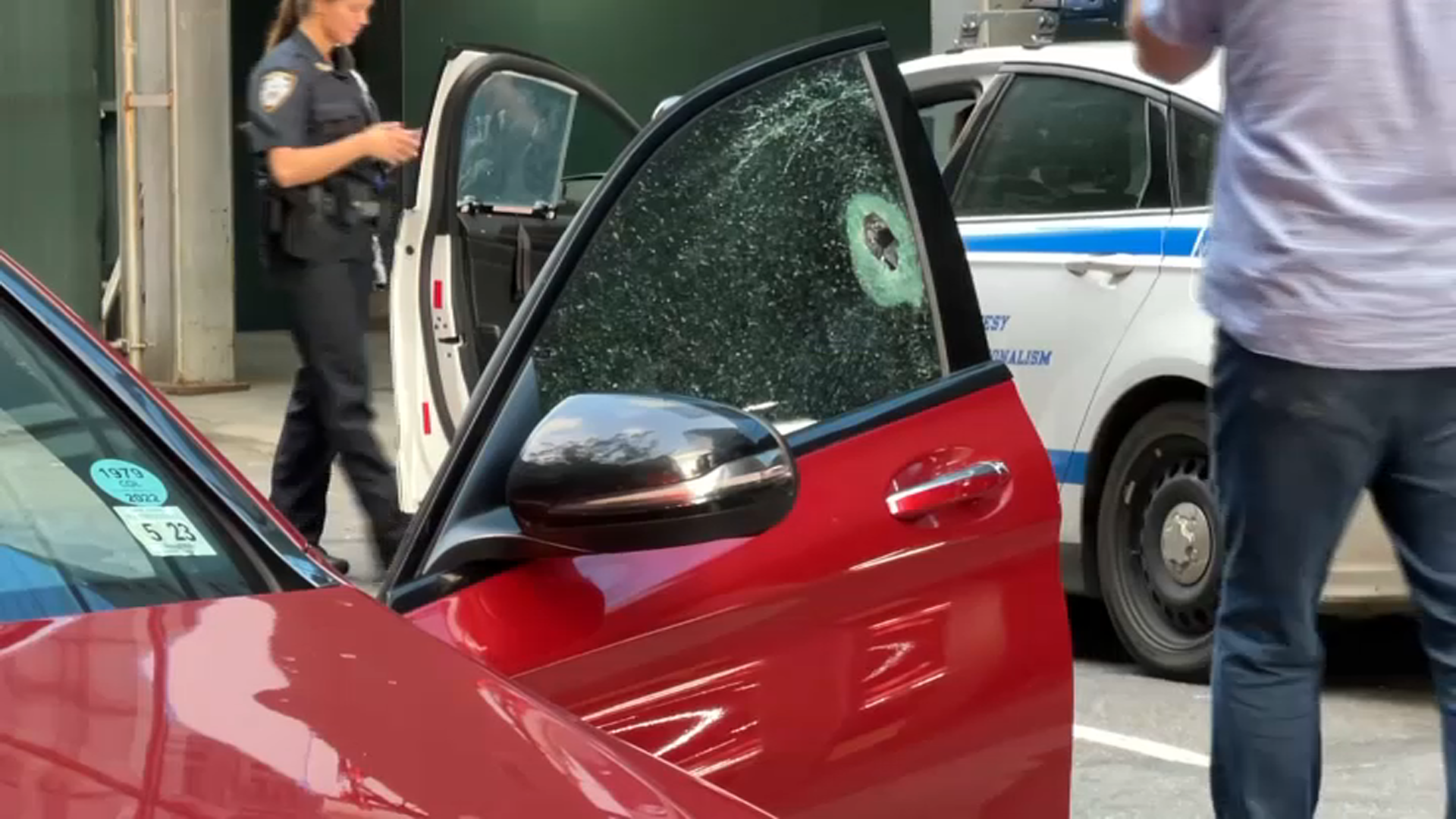 Bullet hole pierces window of car parked near Midtown church.
