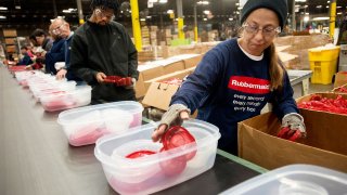 Employees assemble food containers on a production line at the Newell Rubbermaid factory in Mogadore, Ohio.