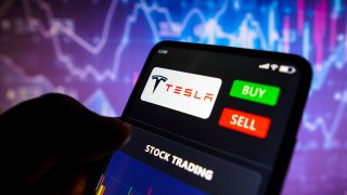 In this photo illustration the stock trading graph of Tesla, Inc. seen on a smartphone screen.