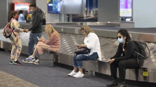 Travelers at LaGuardia Airport (LGA) in the Queens borough of New York, US, on Friday, July 2, 2022. As travel is ramping up for the July 4th holiday, staffing shortages are causing problems for some of the nations largest airlines.