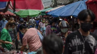 Customers shop at a wet market in Bangkok, Thailand, on July 2, 2022. Thailand’s economy grew at a slower pace than expected in the second quarter, official data showed on Monday, helped by increased activity and a rebound in tourism as Covid-19 curbs were eased, but surging inflation remains a concern.