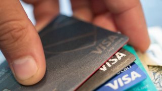 FILE – Visa credit cards are seen on Aug. 11, 2019, in New Orleans. Payment processor Visa Inc. said late Saturday, Sept. 10, 2022, that it plans to start separately categorizing sales at gun shops.