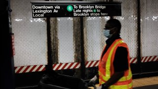 A worker walks along a platform of the New York City subway on June 03, 2021 in New York City